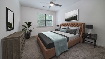The hendrix apartments bedroom with bed and ceiling fan